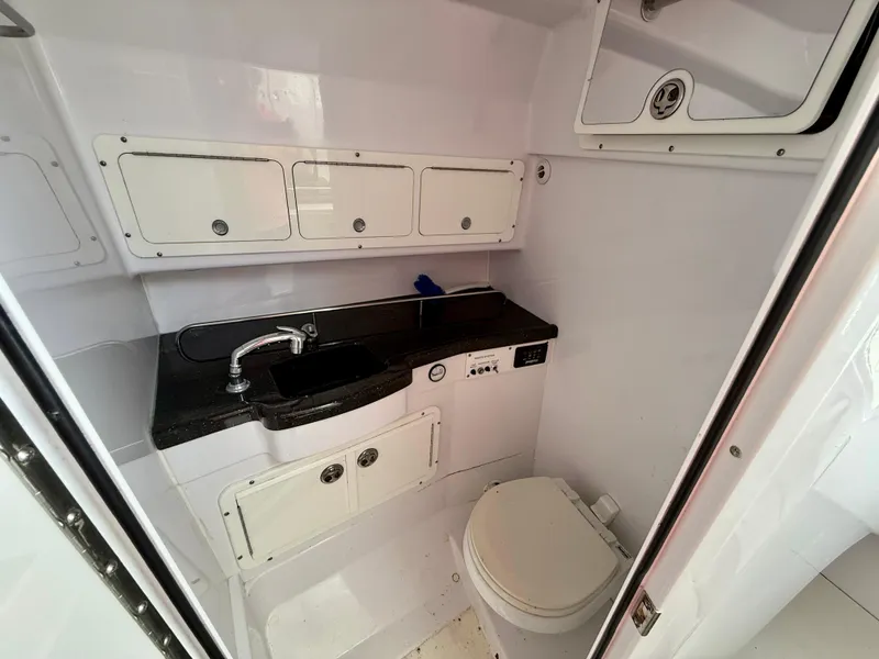 Slide: The Image of 2008 Southport 28 Express boat interior with sink, storage cabinets, and toilet. - 22