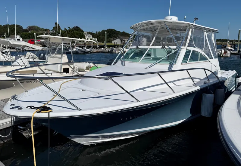 Slide: The Image of 2008 Southport 28 Express boat docked at marina under clear blue sky. - 4