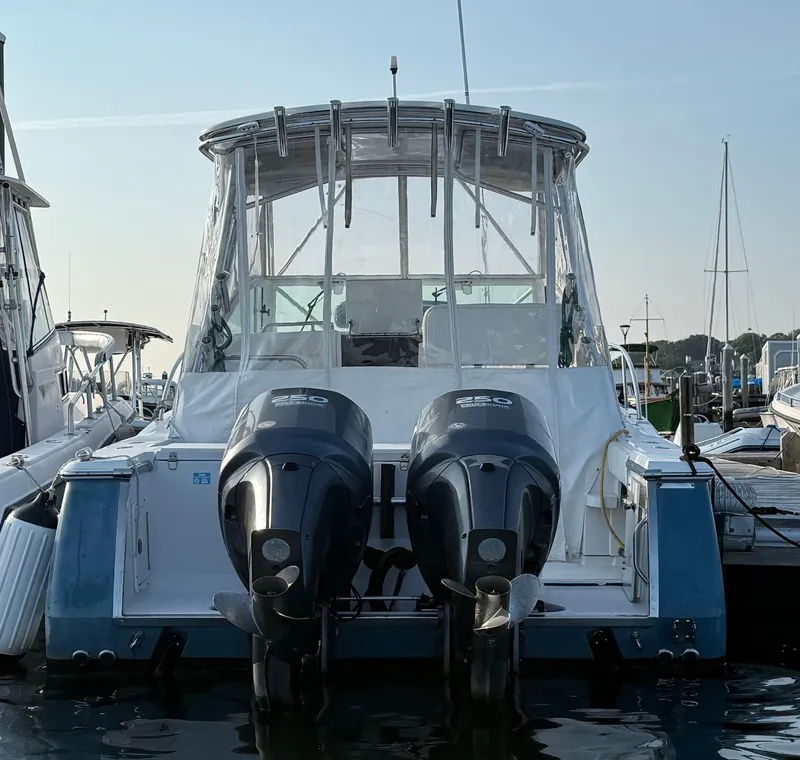 Slide: The Image of 2008 Southport 28 Express boat with dual outboard engines docked at marina. - 7