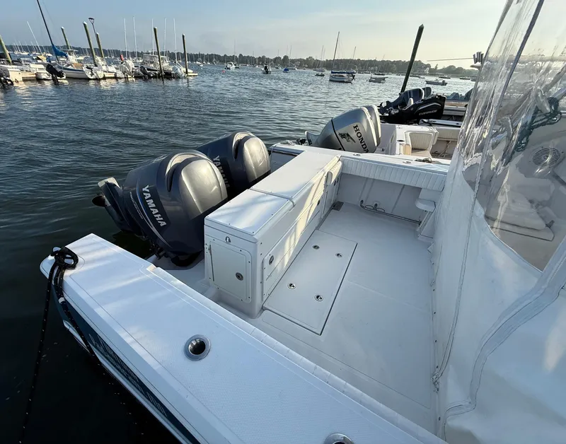Slide: The Image of 2008 Southport 28 Express boat with Yamaha engines docked in a marina. - 8