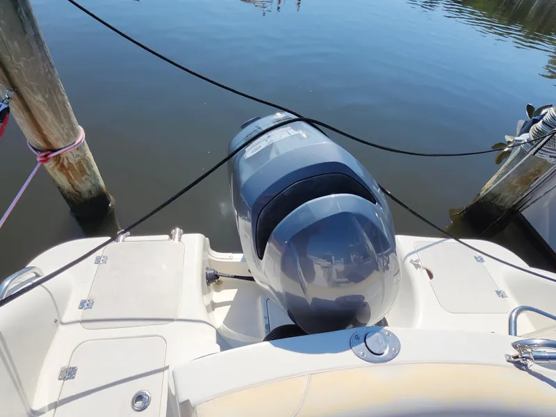 Slide: The Image of 2009 Hurricane SunDeck 2000 OB boat with outboard motor docked at marina. - 11