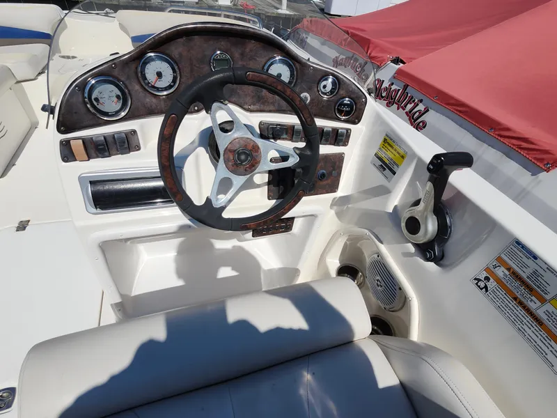 Slide: The Image of 2009 Hurricane SunDeck 2000 OB boat dashboard with steering wheel and controls. - 6