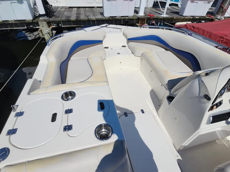 Slide: The Image of 2009 Hurricane SunDeck 2000 OB boat interior with seating and cup holders. - 8