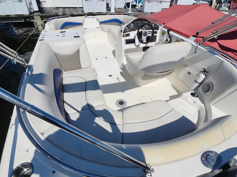 Slide: The Image of 2009 Hurricane SunDeck 2000 OB boat interior with seating and steering wheel. - 9