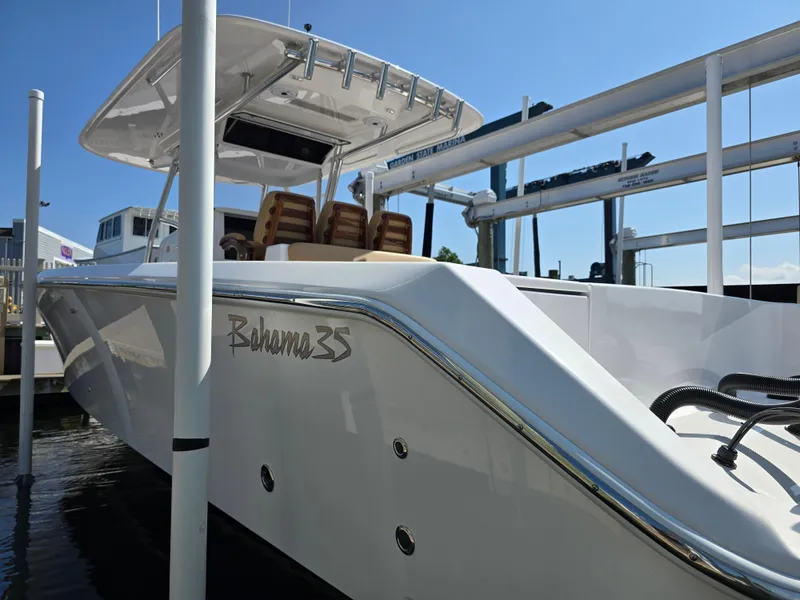 Slide: The Image of 2025 Bahama 35 Super Center Console boat docked at marina. - 13