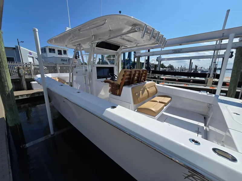 Slide: The Image of 2025 Bahama 35 Super Center Console boat docked, featuring sleek design and spacious seating. - 14
