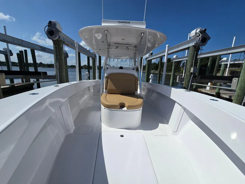 Slide: The Image of 2025 Bahama 35 Super Center Console boat docked, featuring sleek design and spacious seating. - 21