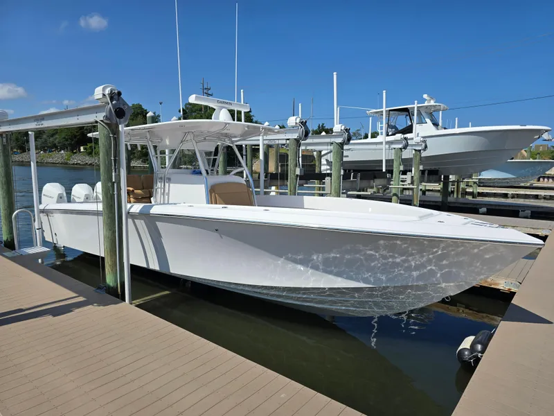 Slide: The Image of 2025 Bahama 35 Super Center Console boat docked at marina. - 3