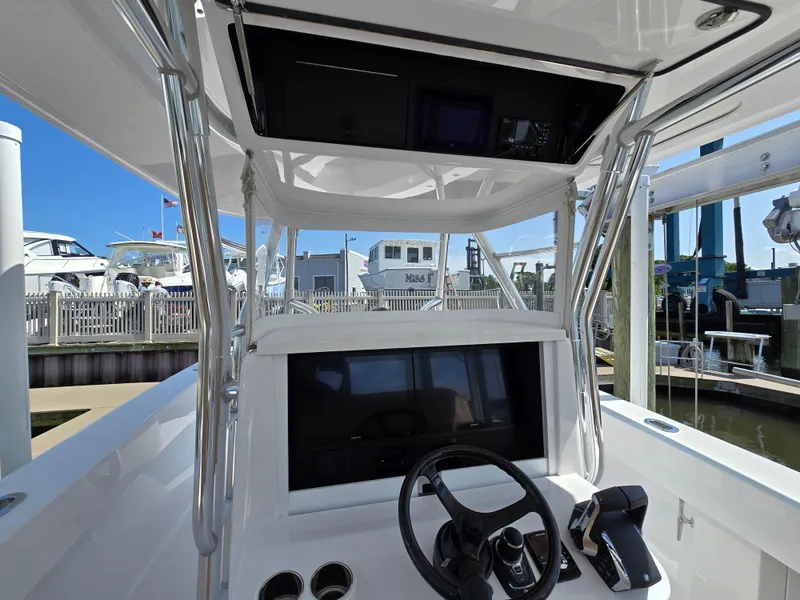 Slide: The Image of 2025 Bahama 35 Super Center Console boat helm with steering wheel and controls. - 5