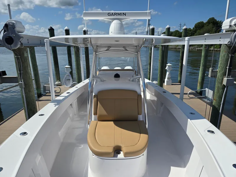 Slide: The Image of 2025 Bahama 35 Super Center Console boat docked, featuring tan seating and Garmin equipment. - 7
