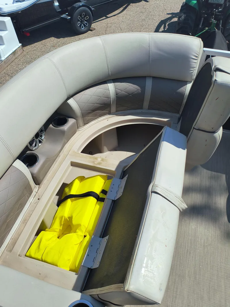 Slide: The Image of 2017 Bennington 24 SSBXP-SPS boat seat storage with yellow life jackets inside. - 13