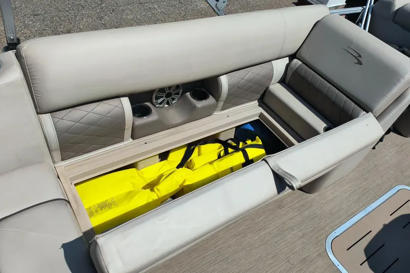 Slide: The Image of 2017 Bennington 24 SSBXP-SPS boat seat storage with yellow life jackets. - 15