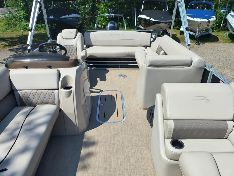 Slide: The Image of 2017 Bennington 24 SSBXP-SPS pontoon boat interior with beige seating and steering console. - 16