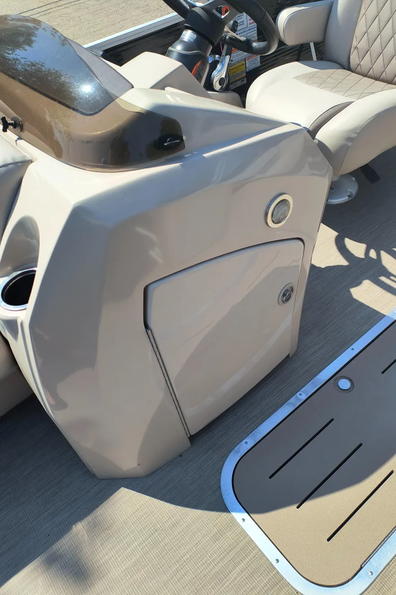 Slide: The Image of 2017 Bennington 24 SSBXP-SPS boat interior with beige console and seating. - 18