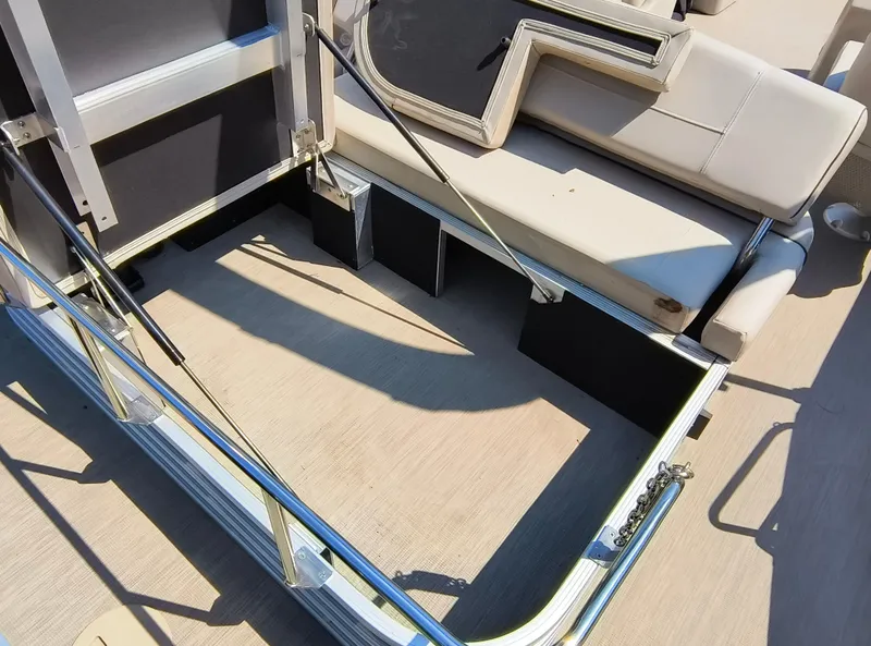Slide: The Image of 2017 Bennington 24 SSBXP-SPS boat interior with beige seating and metal railings. - 27