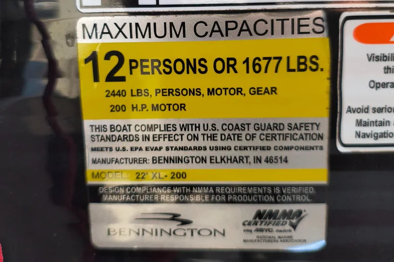 Slide: The Image of 2017 Bennington 24 SSBXP-SPS capacity label: 12 persons, 1677 lbs, 200 HP motor. - 30