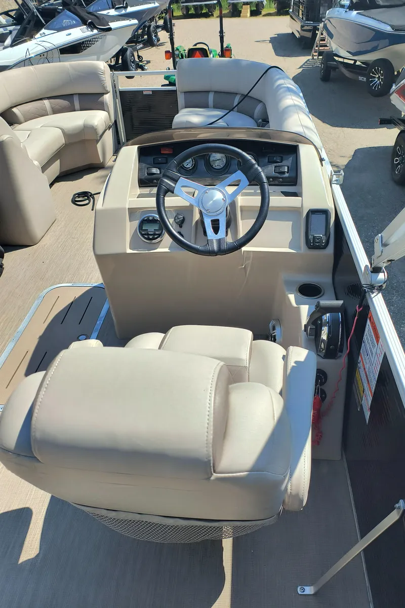 Slide: The Image of 2017 Bennington 24 SSBXP-SPS boat interior with steering wheel and seating area. - 8