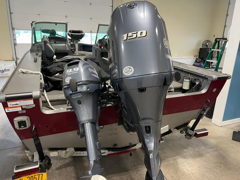 Slide: The Image of 2017 Lund 1875 Pro-V Sport boat with dual Yamaha outboard motors in a garage. - 2