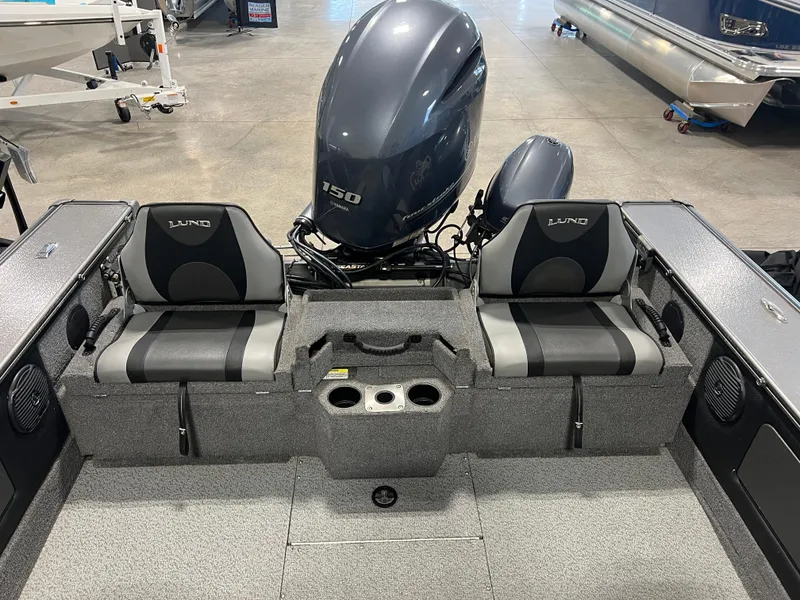Slide: The Image of 2017 Lund 1875 Pro-V Sport boat interior with Yamaha 150 engine, dual seats, and storage compartments. - 5
