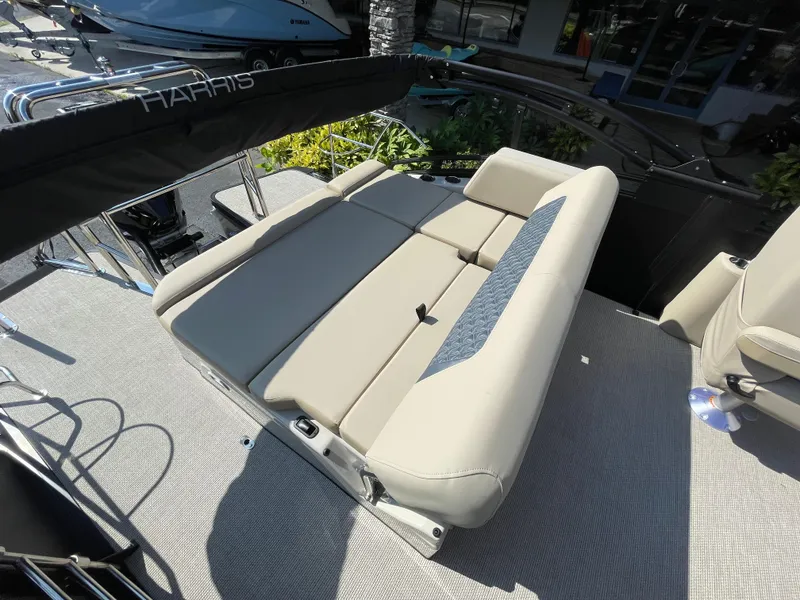 Slide: The Image of 2026 Harris Solstice 230 boat interior with beige seating and modern design. - 11