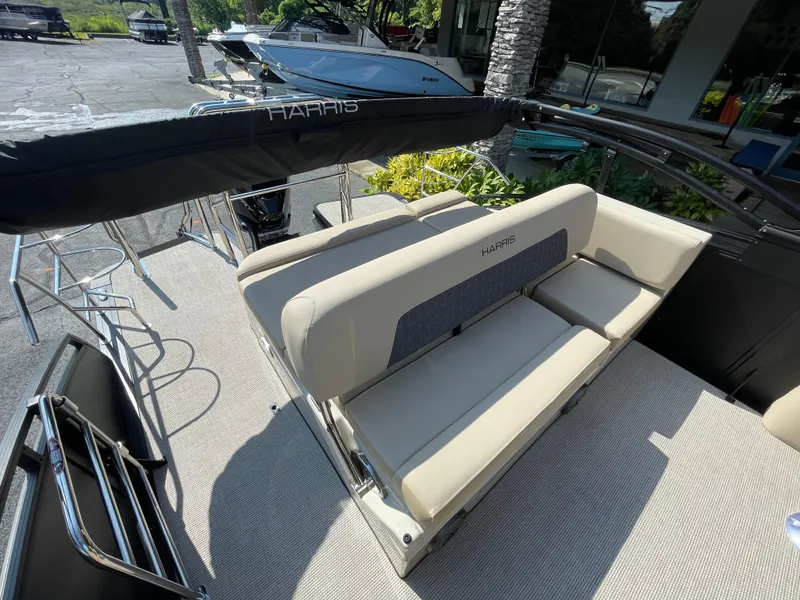 Slide: The Image of 2026 Harris Solstice 230 boat interior with beige seating and sleek design. - 13