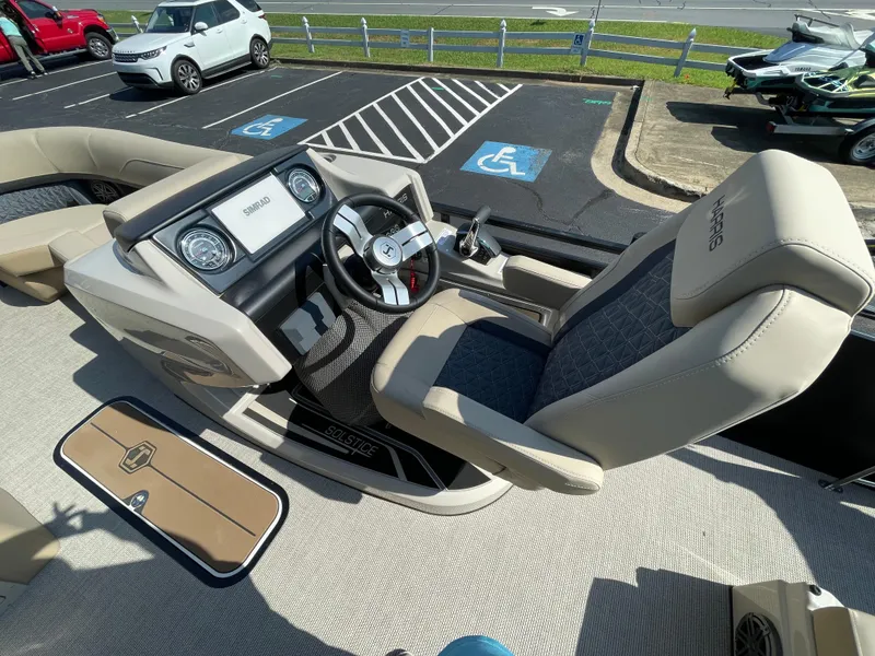 Slide: The Image of 2026 Harris Solstice 230 boat interior with modern dashboard and comfortable seating. - 15