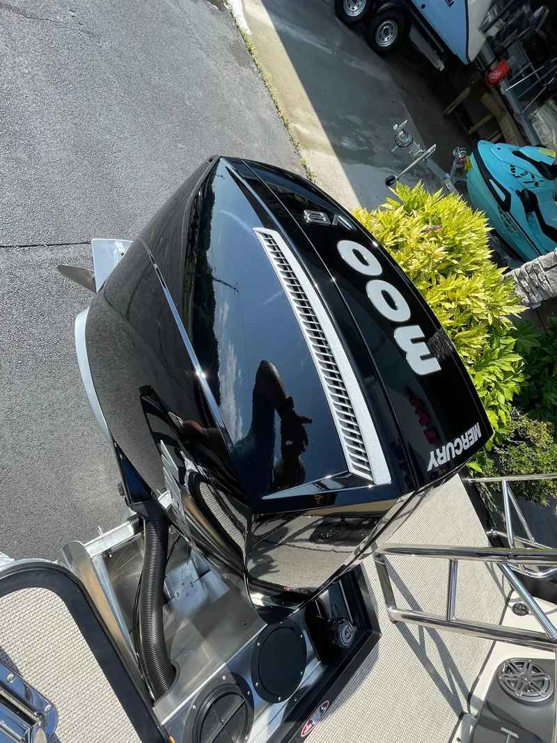 Slide: The Image of 2026 Harris Solstice 230 with Mercury 400 outboard engine, parked on a sunny day. - 17