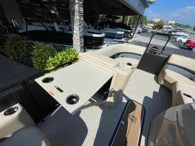 Slide: The Image of 2026 Harris Solstice 230 pontoon boat interior with beige seating and foldable table. - 8