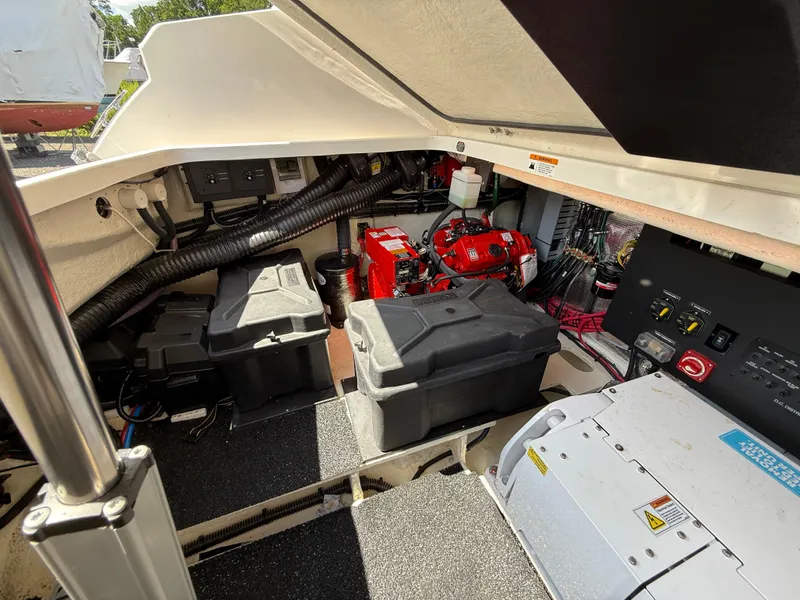 Slide: The Image of Engine compartment of a 2022 Regal 36 XO boat, showcasing batteries and wiring. - 12