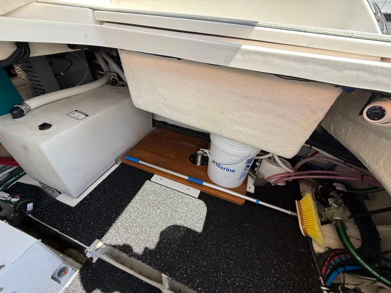 Slide: The Image of 2022 Regal 36 XO boat storage area with equipment and cleaning supplies. - 13