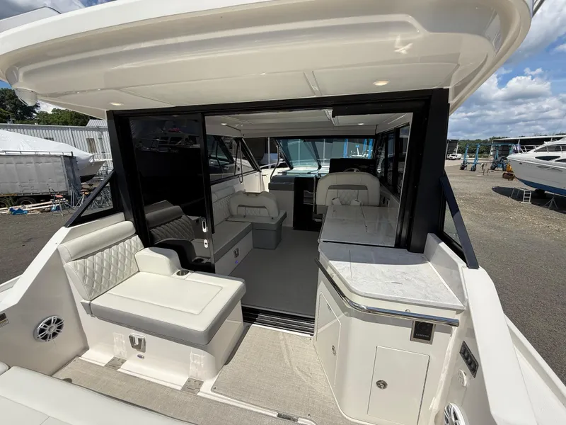 Slide: The Image of 2022 Regal 36 XO yacht interior with luxurious seating and modern design. - 16