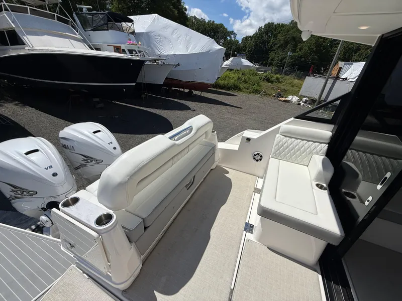 Slide: The Image of 2022 Regal 36 XO boat interior with seating and twin Yamaha V8 engines. - 19