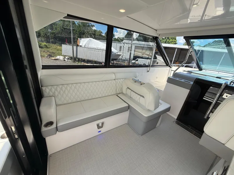 Slide: The Image of Luxurious interior of 2022 Regal 36 XO yacht with elegant seating and panoramic windows. - 23