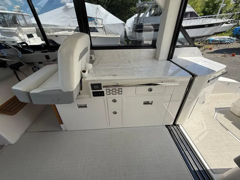 Slide: The Image of Interior of 2022 Regal 36 XO yacht with modern seating and sleek cabinetry. - 25