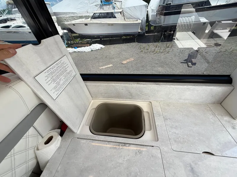 Slide: The Image of Interior of 2022 Regal 36 XO yacht with countertop storage compartment open. - 28