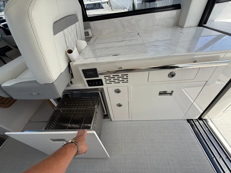 Slide: The Image of 2022 Regal 36 XO yacht interior with open drawer and modern cabinetry. - 30
