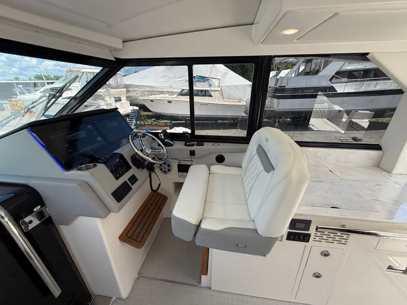 Slide: The Image of Interior of 2022 Regal 36 XO yacht cockpit with modern controls and seating. - 31