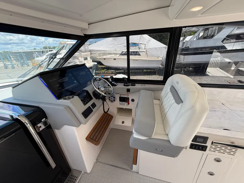 Slide: The Image of 2022 Regal 36 XO boat helm with modern controls and comfortable seating. - 32