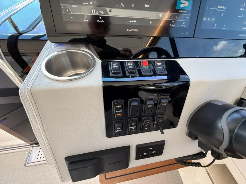 Slide: The Image of Control panel of 2022 Regal 36 XO boat with Garmin display and switches. - 33