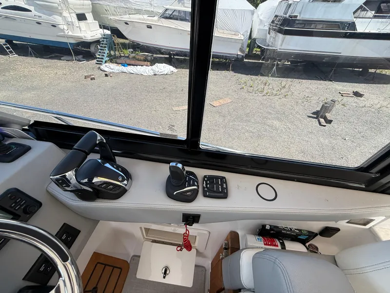 Slide: The Image of Interior view of 2022 Regal 36 XO boat cockpit with controls and steering wheel. - 35