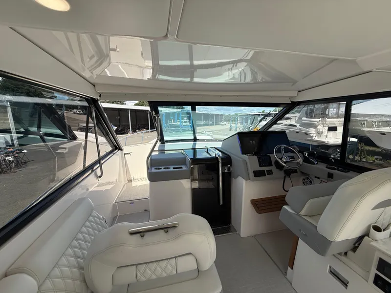 Slide: The Image of Interior view of 2022 Regal 36 XO yacht cockpit with modern helm and seating. - 36