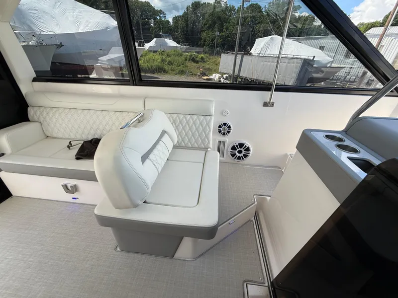 Slide: The Image of 2022 Regal 36 XO boat interior with white seating and cup holders. - 38