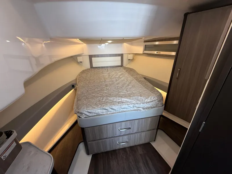 Slide: The Image of 2022 Regal 36 XO cabin interior with bed, storage, and modern design. - 45