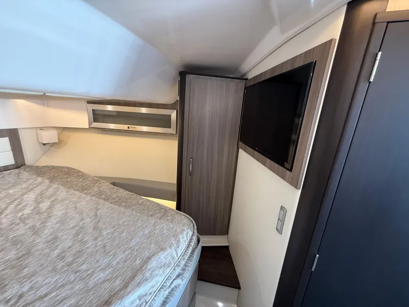 Slide: The Image of 2022 Regal 36 XO cabin interior with bed, wardrobe, and wall-mounted TV. - 46