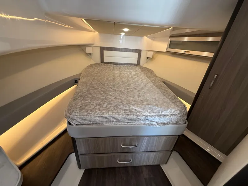 Slide: The Image of 2022 Regal 36 XO boat interior cabin with bed and storage drawers. - 48