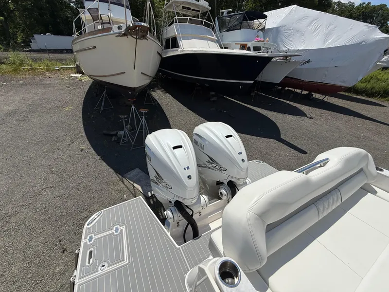 Slide: The Image of 2022 Regal 36 XO boat with twin Yamaha V8 engines in a storage yard. - 5