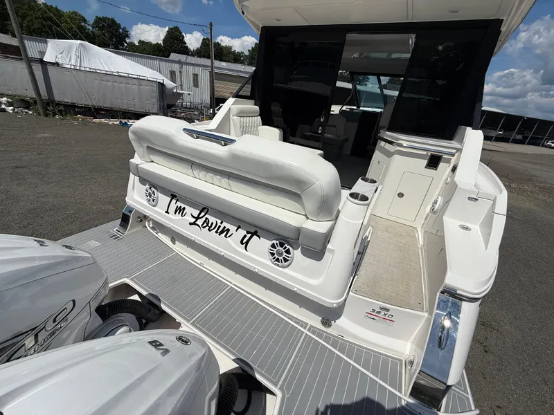 Slide: The Image of 2022 Regal 36 XO boat with "I'm Lovin' It" text on the back, docked outdoors. - 6