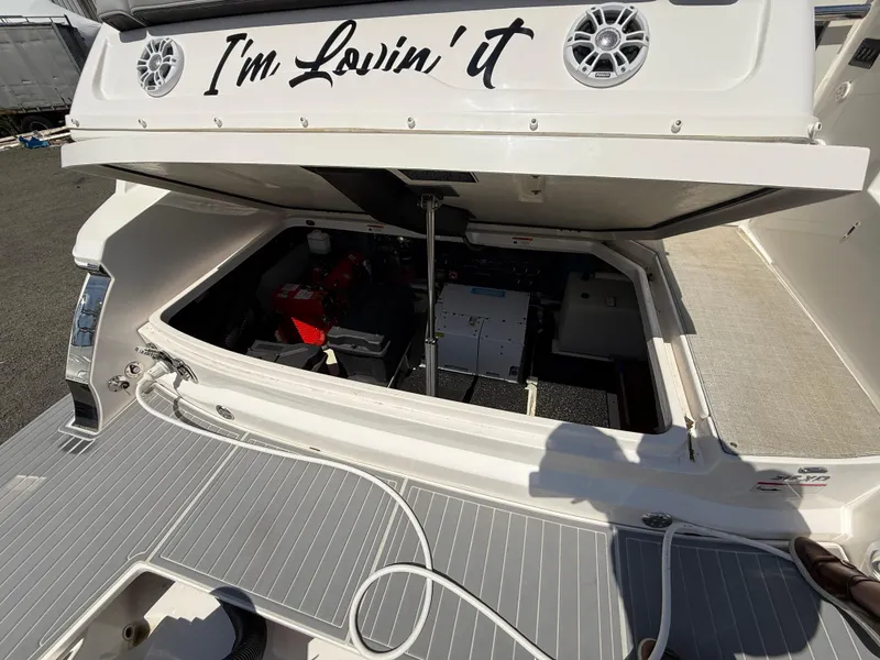 Slide: The Image of 2022 Regal 36 XO boat engine compartment with open hatch and "I'm Lovin' it" text. - 8
