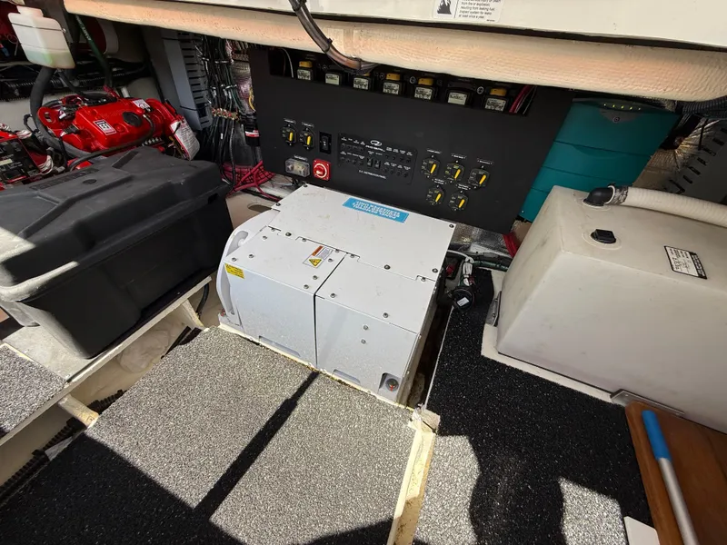 Slide: The Image of Electrical panel and equipment inside a 2022 Regal 36 XO boat engine room. - 9