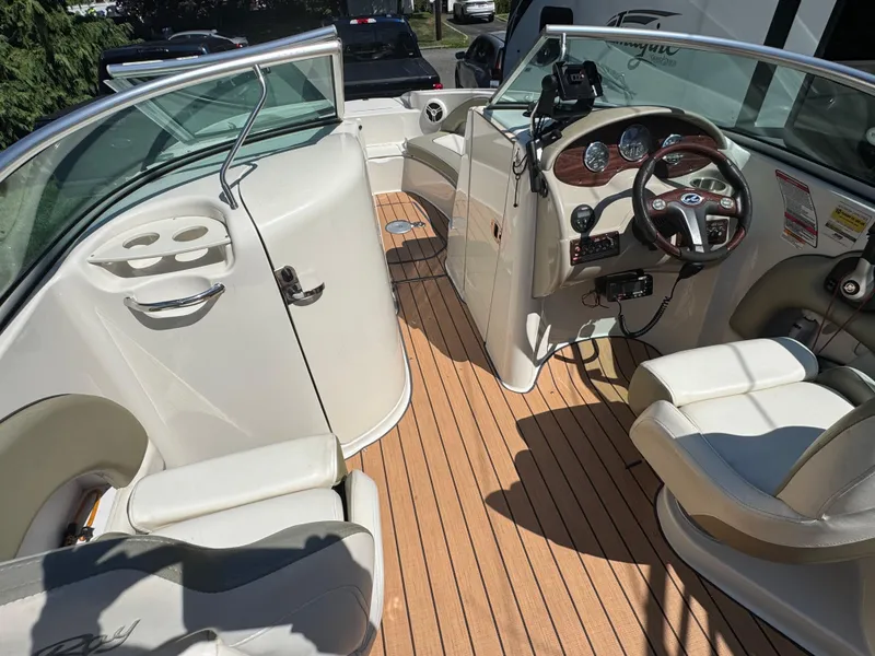 Slide: The Image of 2007 Sea Ray 220 Sundeck interior with steering wheel, seating, and dashboard controls. - 10